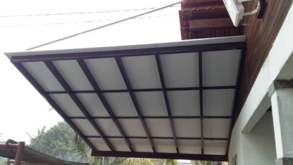 A white awning ACP sheet and panel extends over a house, complementing the white roof, showcasing a sleek and modern design